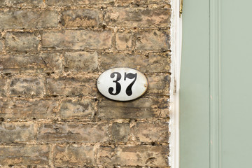 House number 37 sign on wall