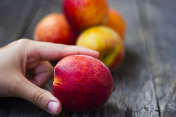 hands girls holding peaches