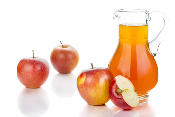 Fresh red apples, glass with juice on white background.