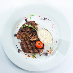grilled steak on a white plate