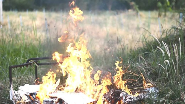 garbage buring in field at countryside