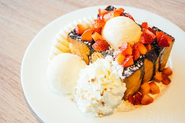 Honey toast with ice cream and strawberry and banana