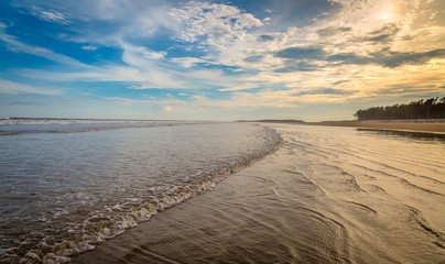 Sea beach with moody sunset sky for wallpaper background content.