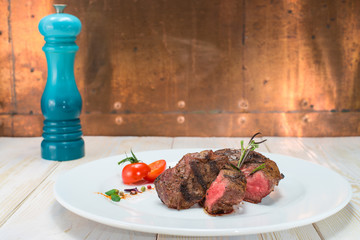 cooked roast beef on a white plate