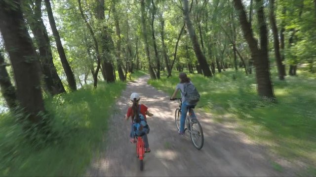 A sports family on bicycles. Mom and daughter on bicycles in the forest.
