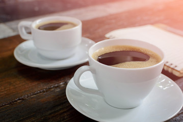 coffee cup clock and news paper on old wooden table nature background