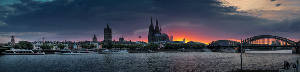 Panorama of the old evening Cologne. Rhine, railway bridge, cathedral