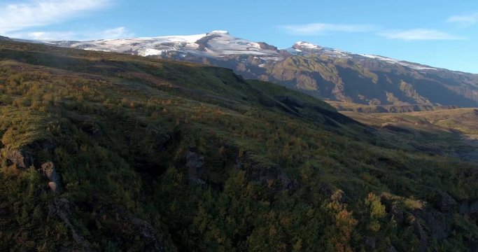 ICELAND – SEPTEMBER 2016 : Aerial shot over mountain revealing glacier in view on a beautiful day in Thorsmörk National Park