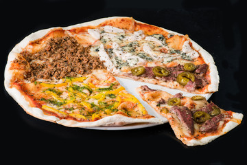 Sliced meat pizza on plate, a dark background