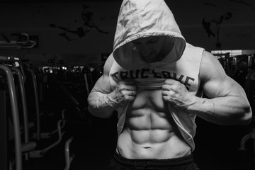 Fototapeta na wymiar Male fitness model showing sixpack abdominal