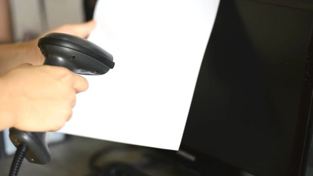 woman hold scanner and scans barcode with laser