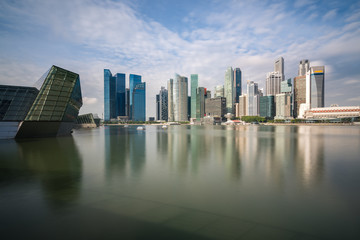 Singapore business district with skyscraper building and reflection at Marina Bay, Singapore.