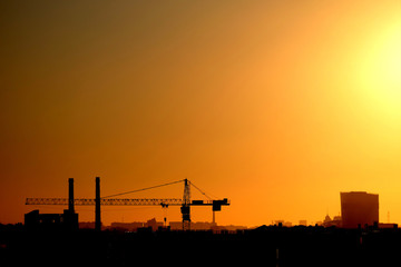 Photo of a building process in the city in the sunset.