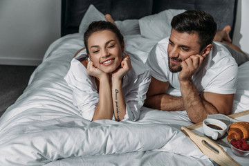 Fototapeta premium Happy couple in love having breakfast in bed