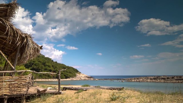 timelapse of a wooden shack on beautiful limoni beach in mljet island, croatia with stunning crystal clear water of the adriatic sea.