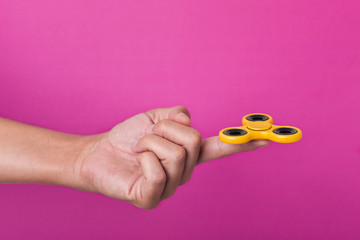 young man playing with a fidget spinner