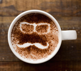 man face in a cup of cappuccino