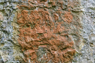 Red staining in the centre of  a piece of cobweb strewn limestone.