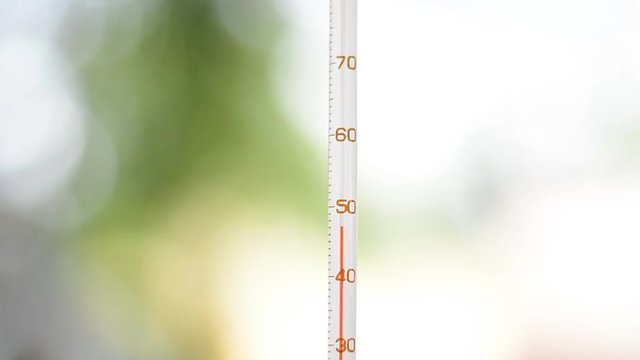 Thermometer indicates high temperature outdoor in Summer