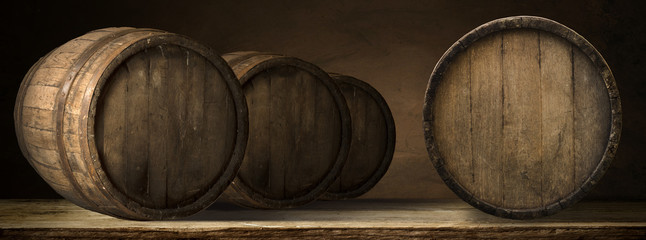 corkscrew and wooden barrel, vineyard on background