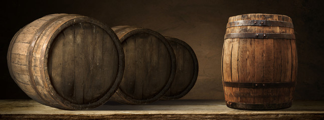 corkscrew and wooden barrel, vineyard on background