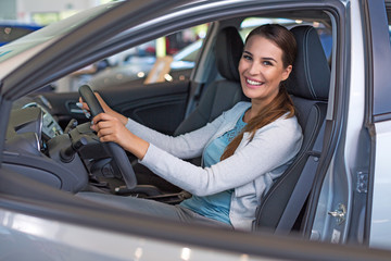 Happy young man with her new car
