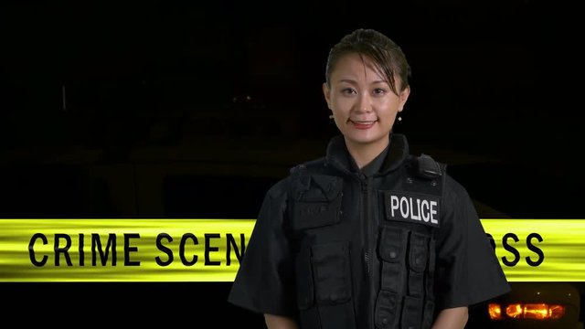 Asian American  female police officer smiling