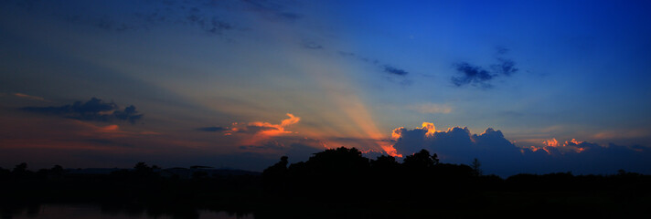 Fototapeta premium panorama sunset in sky beautiful colorful landscape silhouette tree woodland and river reflect the twilight time