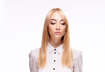 Blonde in a white shirt on a light background portrait