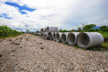Stacked concrete drainage pipe under blue sky
