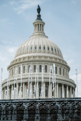Fototapeta na wymiar Dome of U.S. Capitol Behind Water from a Fountain
