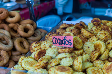 Close up of the coconut bread in tray with text coquifos for snack and donut. Arrange for sell dessert in food market