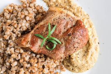 roasted pork mignon on buckwheat porridge and onion sauce