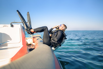 Scuba diver jumping in the water from a boat