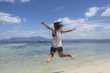 Obraz premium The girl jumped gladly on the beach vacation. Prachuap Khiri Khan, Thailand.jpg