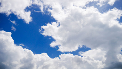 White clouds on brightly blue sky.