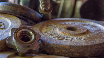 Rusty old Weights slowly rust left abandoned on the floor