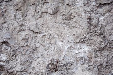 A wall covered with solid gray textured plaster material