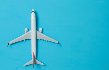 white airplane on a blue background, top view