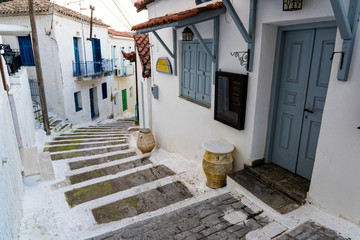 Narrow street with stairs and traditional houses in the old town of Koroni in Peloponnese, Greece