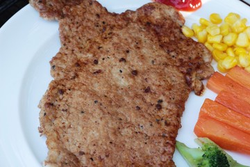 Pork steak with vegetables and tomato sauce.
