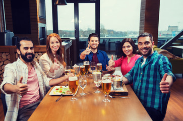 friends dining and drinking beer at restaurant