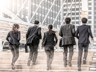 Portrait of hurrying people in suits run forwards for work with optimistic expression.Business...