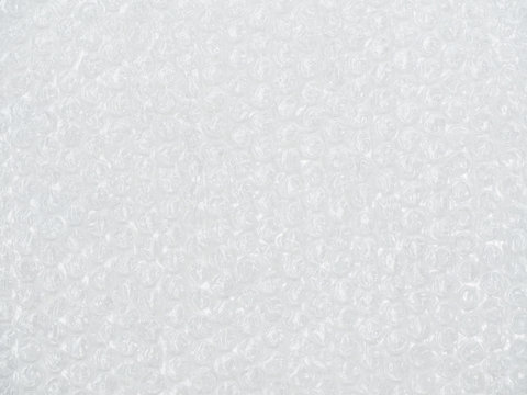 Bubble wrap background, white plastic surface, texture shock proof packing, polyethylene air bubble. Cushioning packing material.