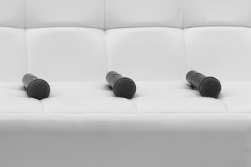 Three microphone laying on white background, close up