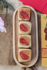 Festival moon cake with red envelopes, Chinese New Year.