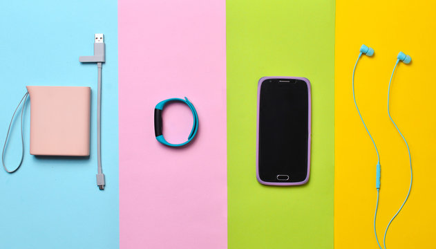Power bank, smart watches, headphones, smartphone lined on a colorful  background. Top View. Stock Photo | Adobe Stock