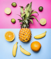 concept of summer fruit set against a bright background mini pineapple, mango, mini bananas, carambola, lime, quince, top view