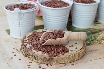 Flax seeds for health on wood background.