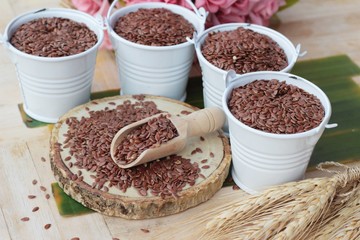 Flax seeds for health on wood background.